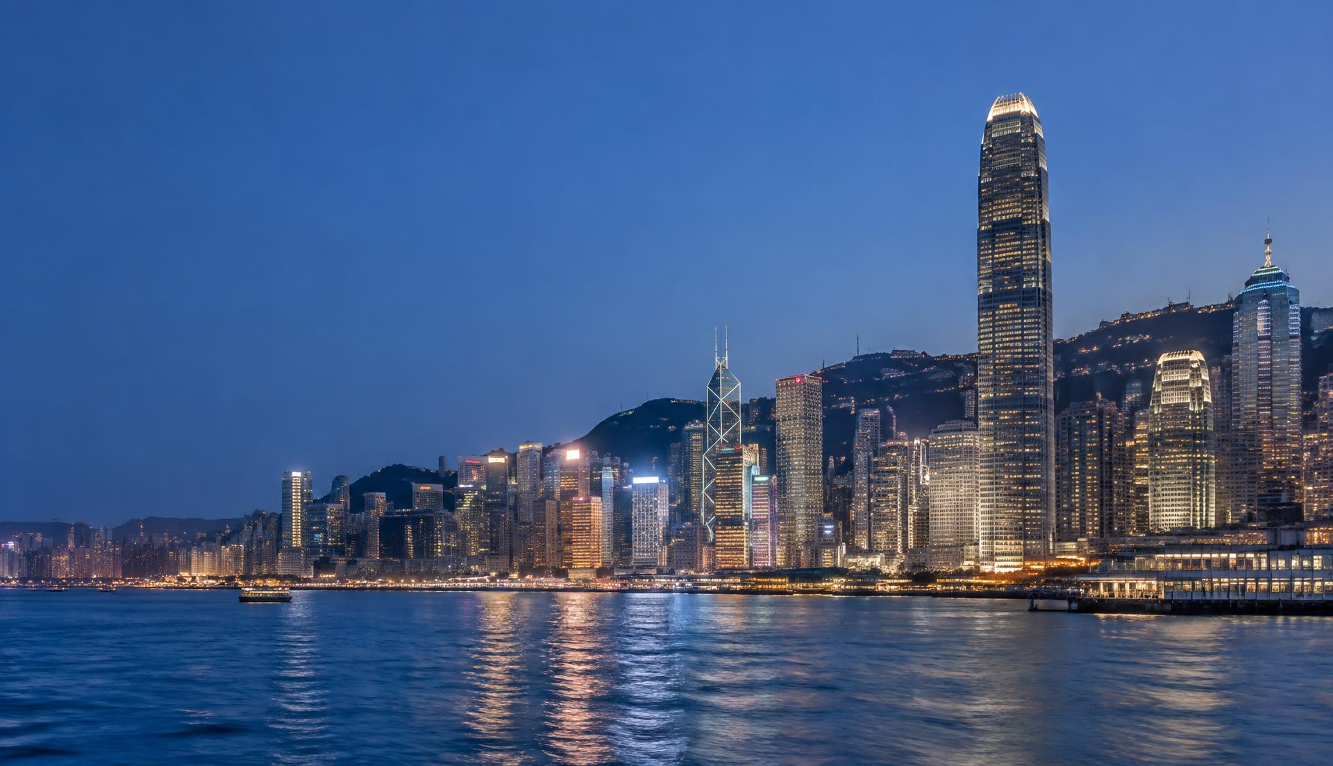 Hong Kong skyline across Victoria Harbour at dusk